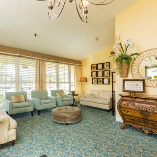 A cozy living room with elegant furniture and large windows providing ample natural light.