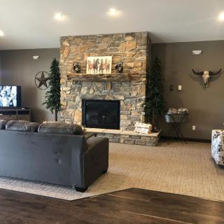 Cozy living room with a stone fireplace and modern decor.