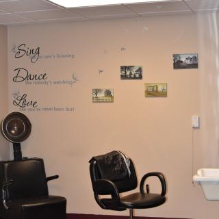 A cozy salon interior featuring styling chairs and vintage wall decor.