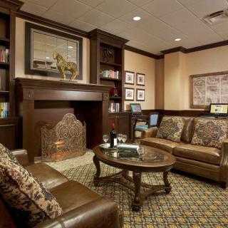 A cozy living room with leather furniture and a fireplace.