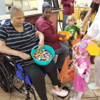 A heartwarming moment of interaction between elderly residents and children during a community activity.