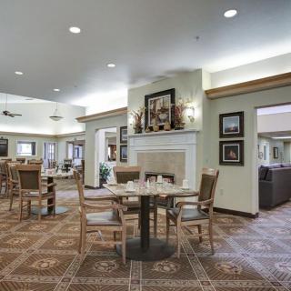 A spacious and elegantly decorated dining area with tables and chairs.