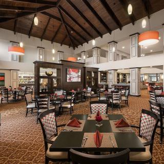 An upscale restaurant dining area with neatly arranged tables and elegant decor.