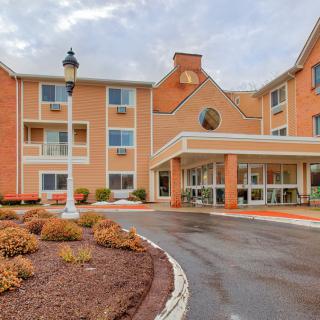 A hotel building with a welcoming entrance and landscaped grounds.