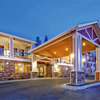 A beautifully lit hotel entrance at night, showcasing modern architecture.