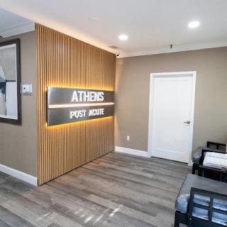 Modern waiting area in a clinic with wood paneling and signage.