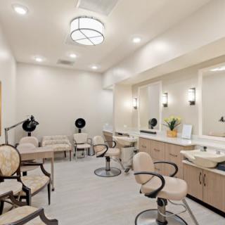 A modern salon interior with styling chairs and mirrors.