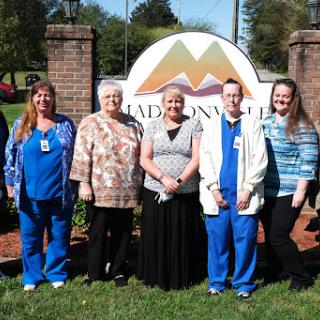 A group of staff members posing outside the Madisonville facility.