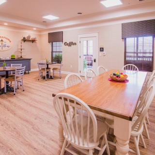 A cozy dining room with wooden floors and modern furnishings.