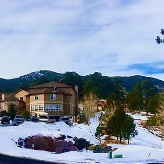 A snowy neighborhood with houses nestled in a mountainous landscape.