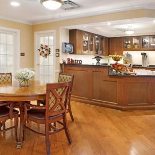 An open concept kitchen and dining area with wooden furniture and warm lighting.