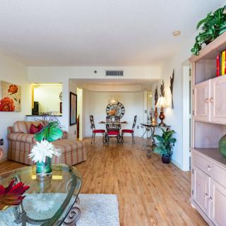 Spacious living room with wooden flooring and a stylish dining area.