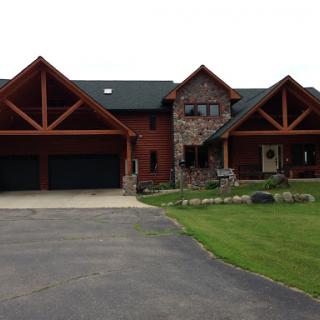 A spacious and beautifully designed residential home with a large garage and well-maintained front yard.