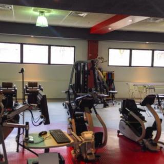 A gym equipped with various fitness machines and exercise equipment.