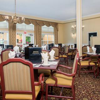 An elegant dining room with neatly arranged tables and chairs.