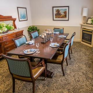 A well-decorated dining room with a set table and elegant furnishings.