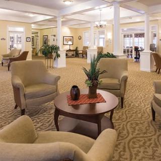 A cozy lobby seating area with armchairs and a coffee table.