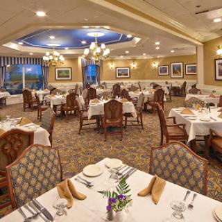 An elegant dining area featuring neatly set tables in a well-decorated restaurant.