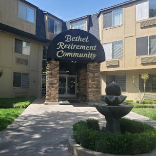 Entrance of Bethel Retirement Community featuring a welcoming fountain and landscaped area.