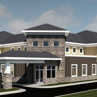 A modern commercial building with a stone facade and multiple rooflines.