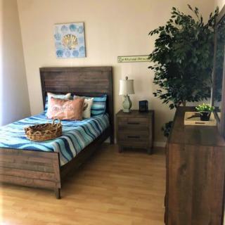 A cozy bedroom with wooden furniture and vibrant decor.