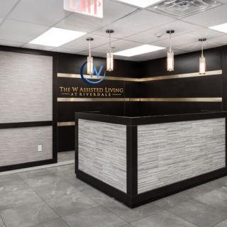 Modern office reception area with a sleek desk and elegant lighting.