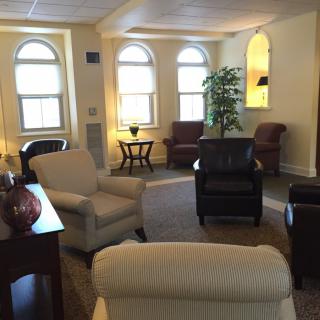 A cozy living room with comfortable seating and large windows.