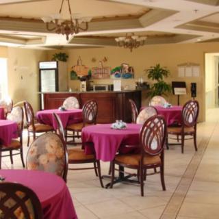 An elegantly decorated restaurant dining area with tables and chairs set up for guests.