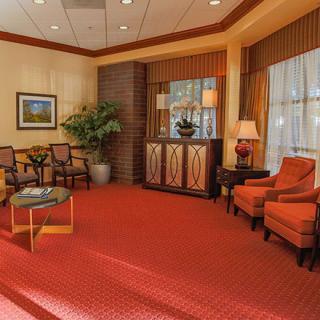 A well-furnished lobby with comfortable seating and warm decor.