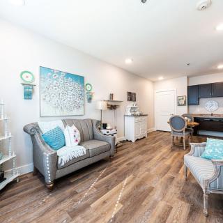 A modern living room with hardwood floors and stylish blue accent decorations.