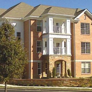 A modern apartment building with a brick facade and balconies.