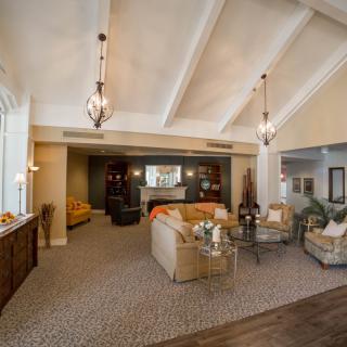 Spacious living area with vaulted ceilings and elegant pendant lighting.