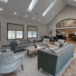 A spacious and modern living room with comfortable seating and ample natural light.