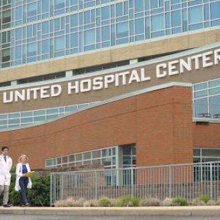 Medical professionals walking in front of United Hospital Center.