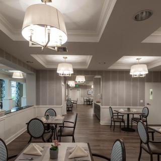 An elegant dining area with neatly arranged tables and stylish lighting.