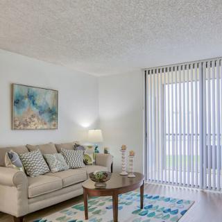 A modern living room with a comfortable sofa, coffee table, and abstract artwork.