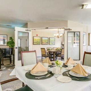 A neatly arranged dining area with tables set for a meal.
