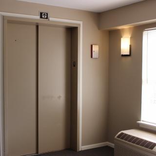 An interior view of a hallway featuring an elevator with closed doors.