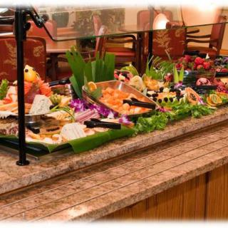 A beautifully arranged buffet with a variety of sushi and fresh foods on display.