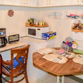 Cozy kitchen corner with a small dining table set and appliances.