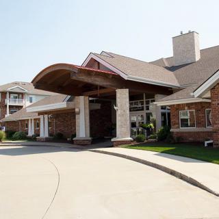 A welcoming entrance to a residential building with a covered driveway.