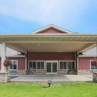 A modern building with a prominent entrance and well-maintained landscaping.