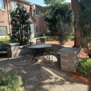 A peaceful outdoor seating area surrounded by greenery, perfect for relaxation.