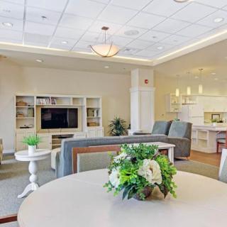 A modern living room with comfortable seating, a large TV unit, and stylish decor.