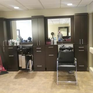 A well-organized hair salon showcasing styling stations and essential tools.