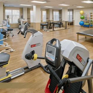 A well-equipped gym with various exercise machines and fitness equipment.