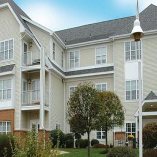 A modern residential apartment building with a landscaped garden.