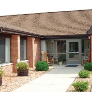 A welcoming entrance to a residential building featuring a well-maintained pathway and landscaping.
