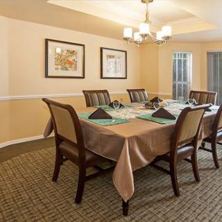 A well-appointed dining room with a set table and elegant lighting.
