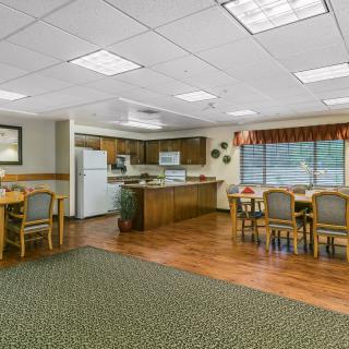 A cozy kitchen and dining area featuring wooden furniture and modern appliances.